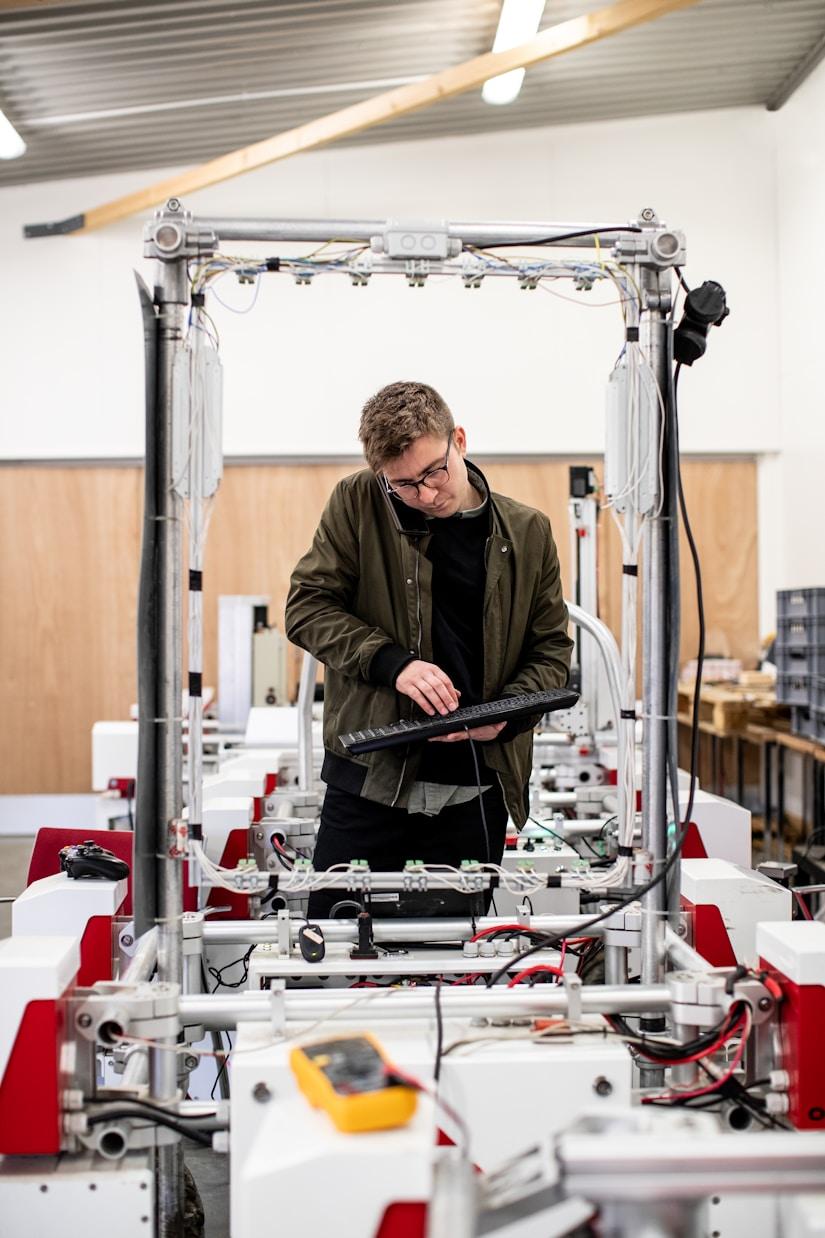 A student programming a gantry robot rig in the JOS Academy lab