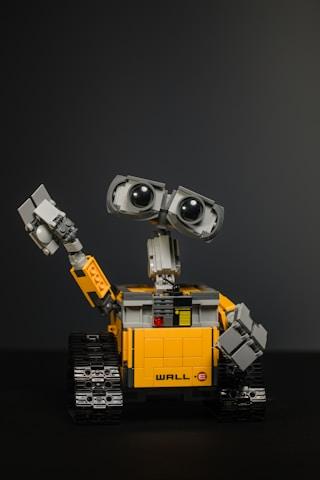 A LEGO WALL-E robot model with its arm raised